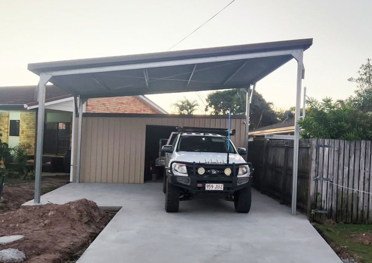 Steel carport with vehicle parked underneath